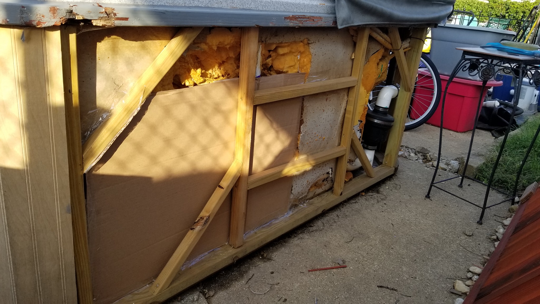Cardboard form built to contain replacement foam insulation