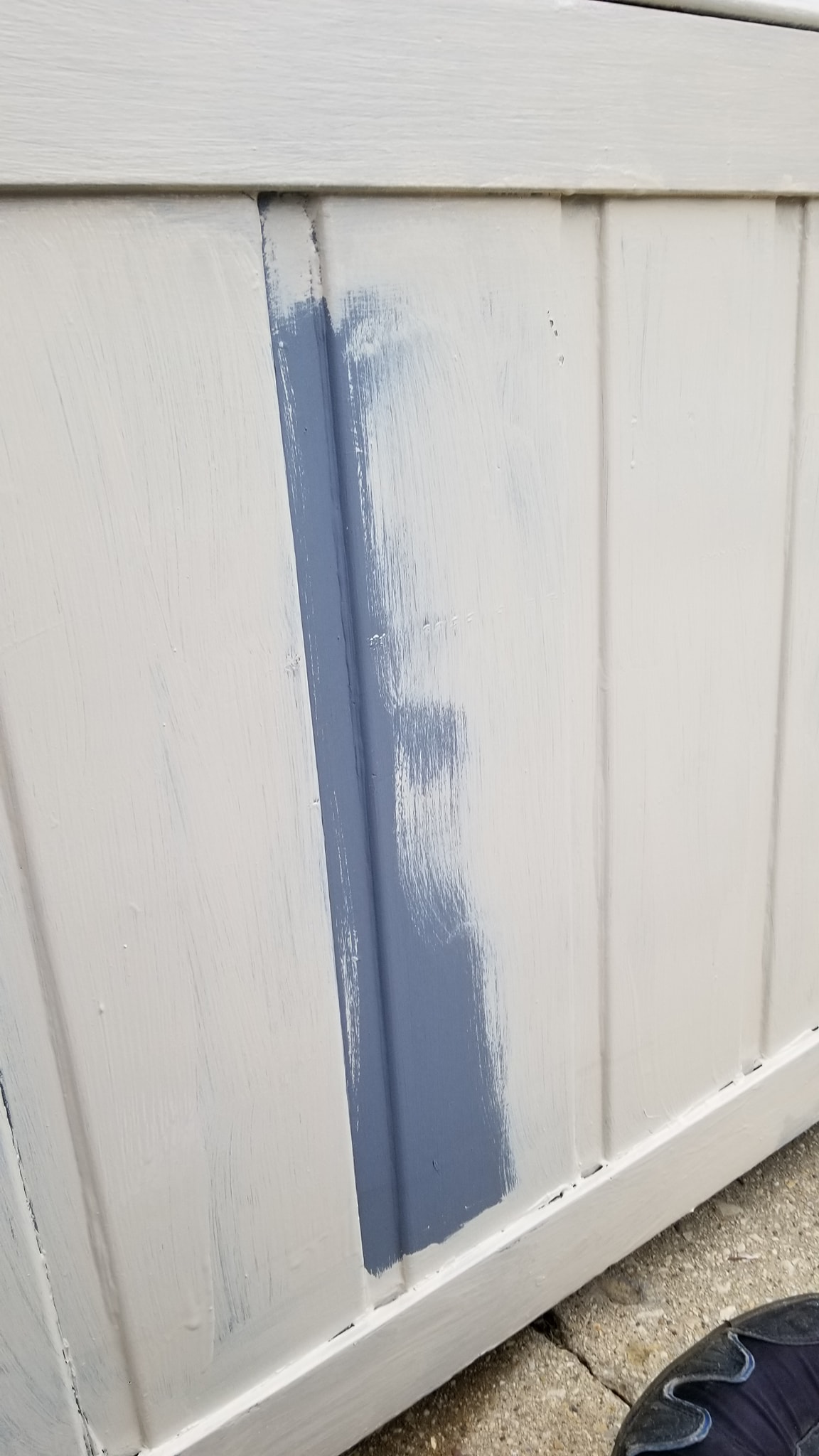 First coat of gray paint being applied to the hot tub cabinet