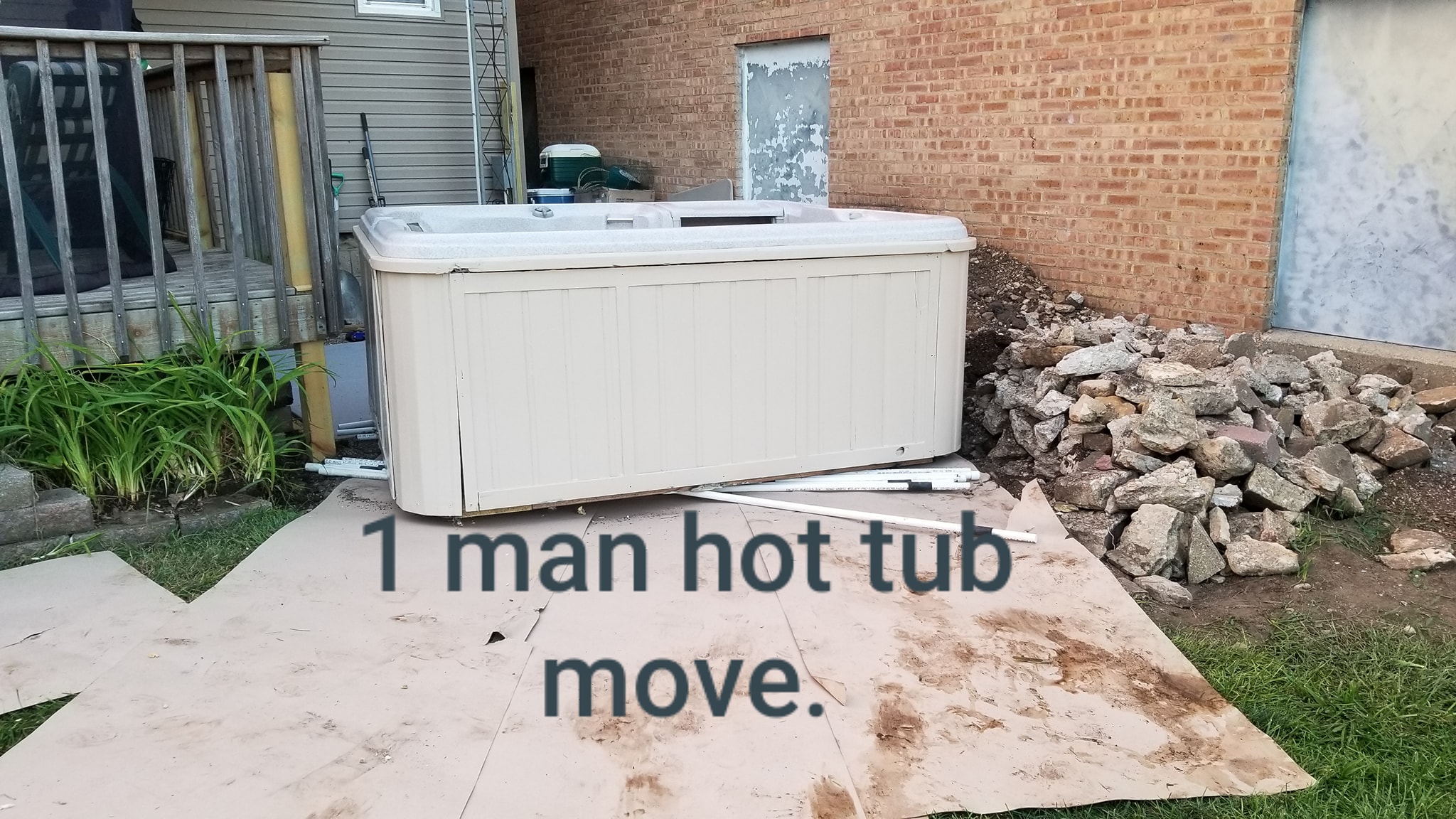Hot tub moving between the deck and rock pile with One-man hot tub move text