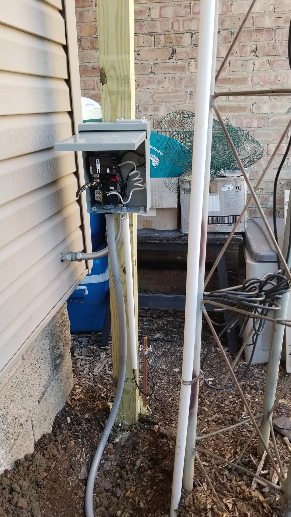 Flexible conduit being installed between the hot tub and electrical box