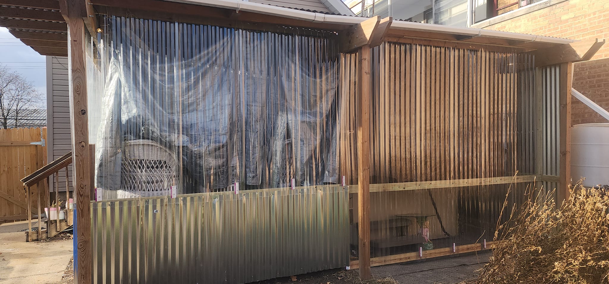 Clear wall panels on the east side of the pergola