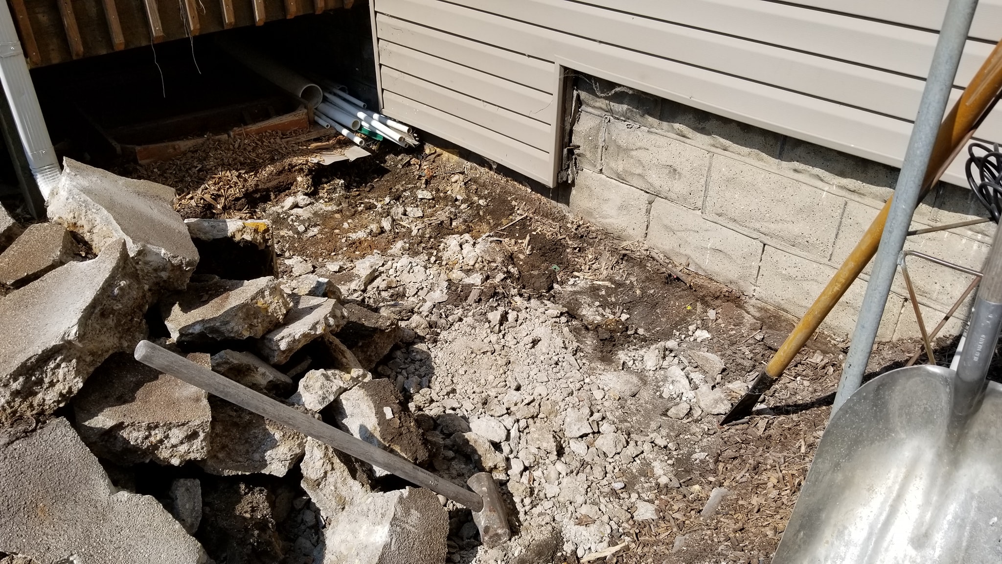 Bare ground after old concrete pad was removed