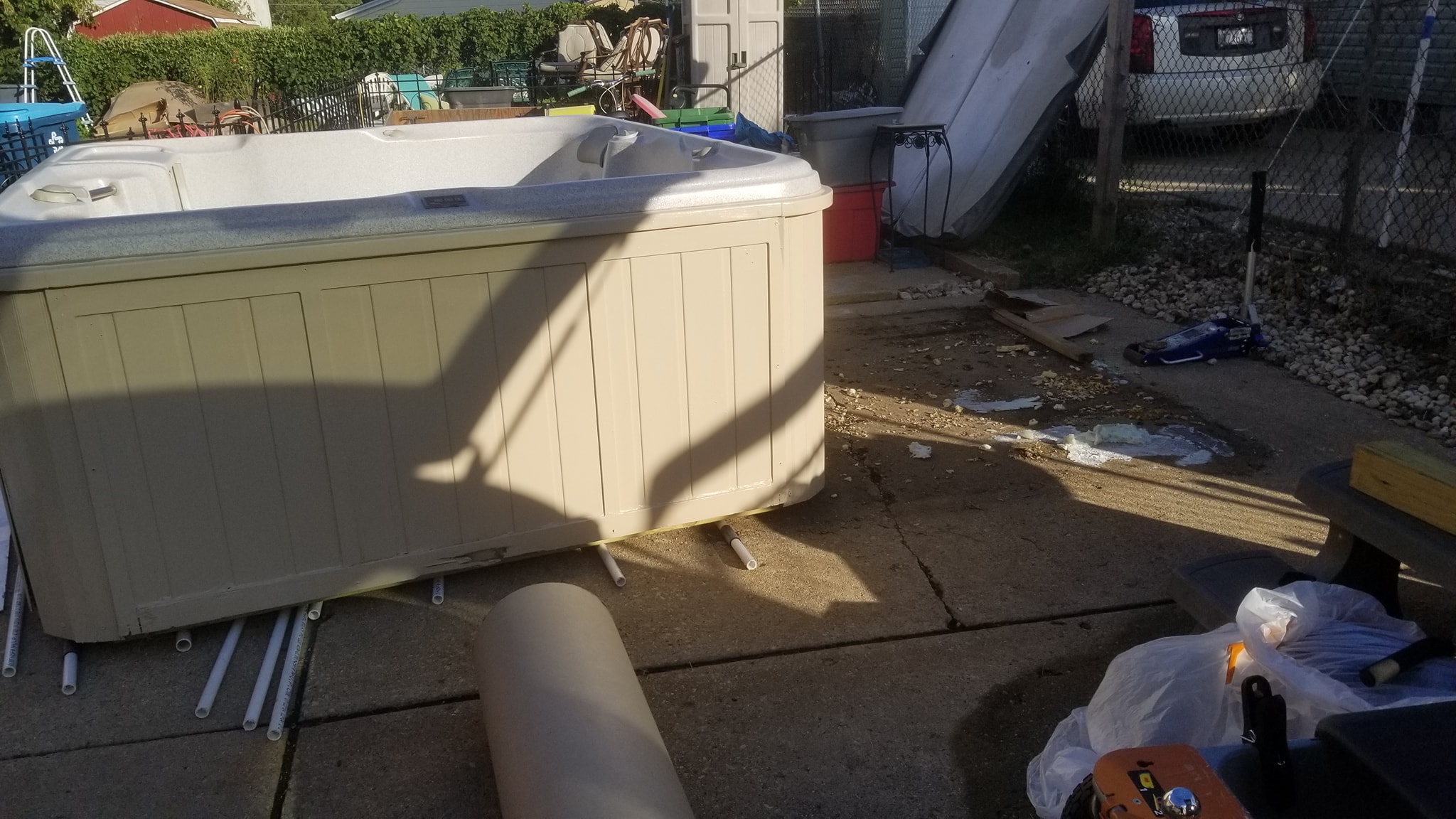 PVC pipes positioned underneath the hot tub before moving it